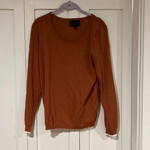 Camel sweater with white sleeve design.